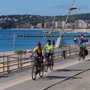 Cycling the Costa Brava Spain - cyclists by Calonge beach Catalonia